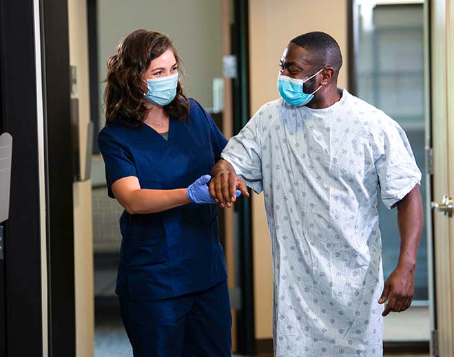 nurse helping patient leave hospital